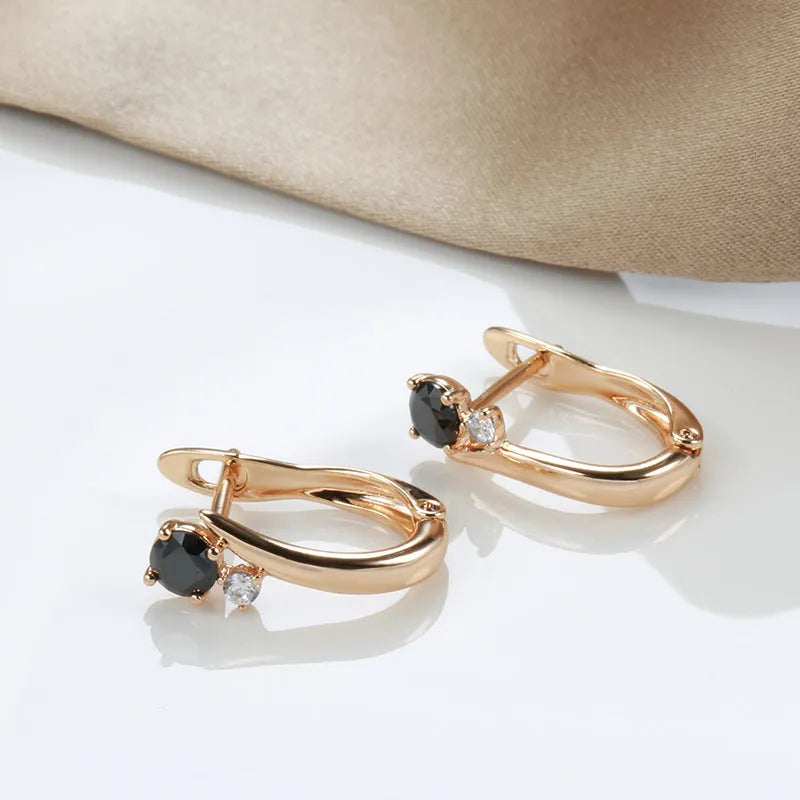 Women's gold geometric drop earrings with black agate stone effect and retro styling