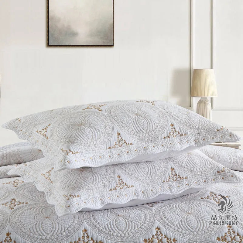 European style embroidered pure cotton bed cover set with two pillowcases on a bed