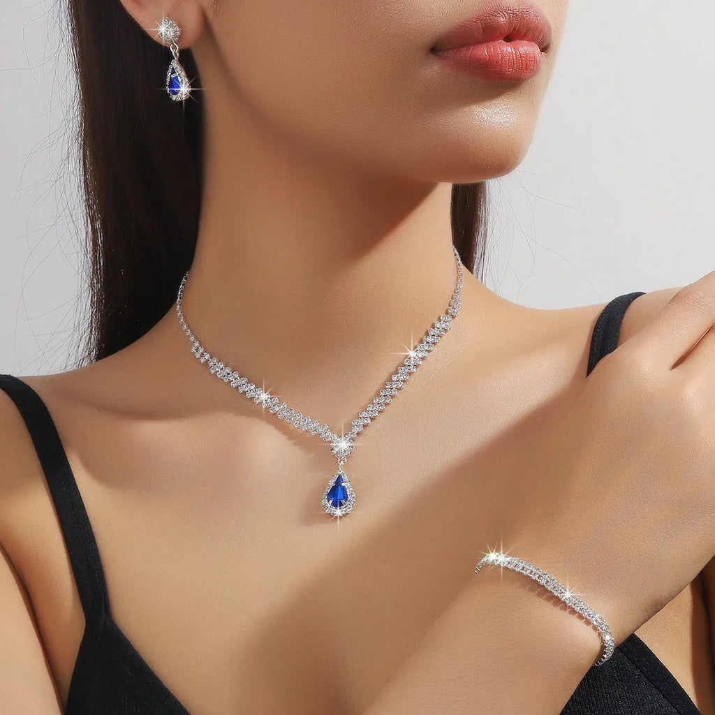 Claw chain rhinestone jewellery set with water drop shapes in a choice of colours, showing necklace, earrings, and optional bracelet.