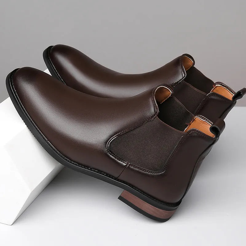 Men's black Chelsea boots with pointed toe design and decorative stitching