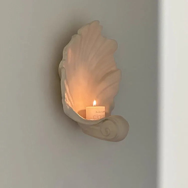 White resin decorative shell ornament for use as a fruit plate or table centrepiece.