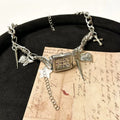 Dark style women's multi-layer cross necklace with twin clavicle chains showing large hemp flower links