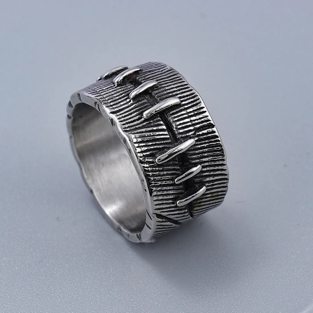Dark punk titanium steel double ring with geometric U-shape design in retro colour on size guide background