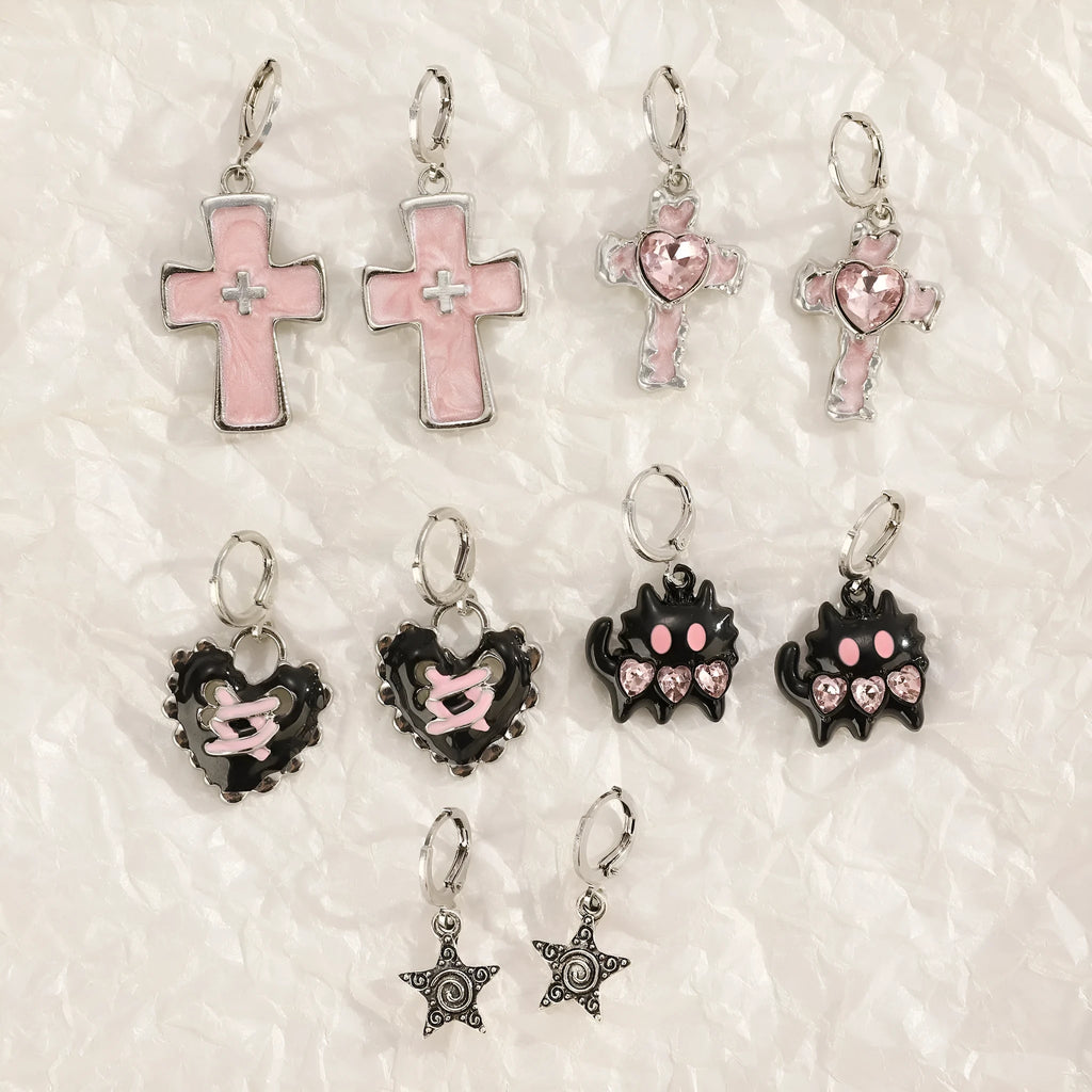 Women's alloy earrings with cross and heart designs in white, black, and silver colour options.