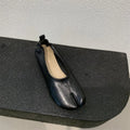 Women's black split toe chunky heel pumps with round head and rubber sole on a white background.