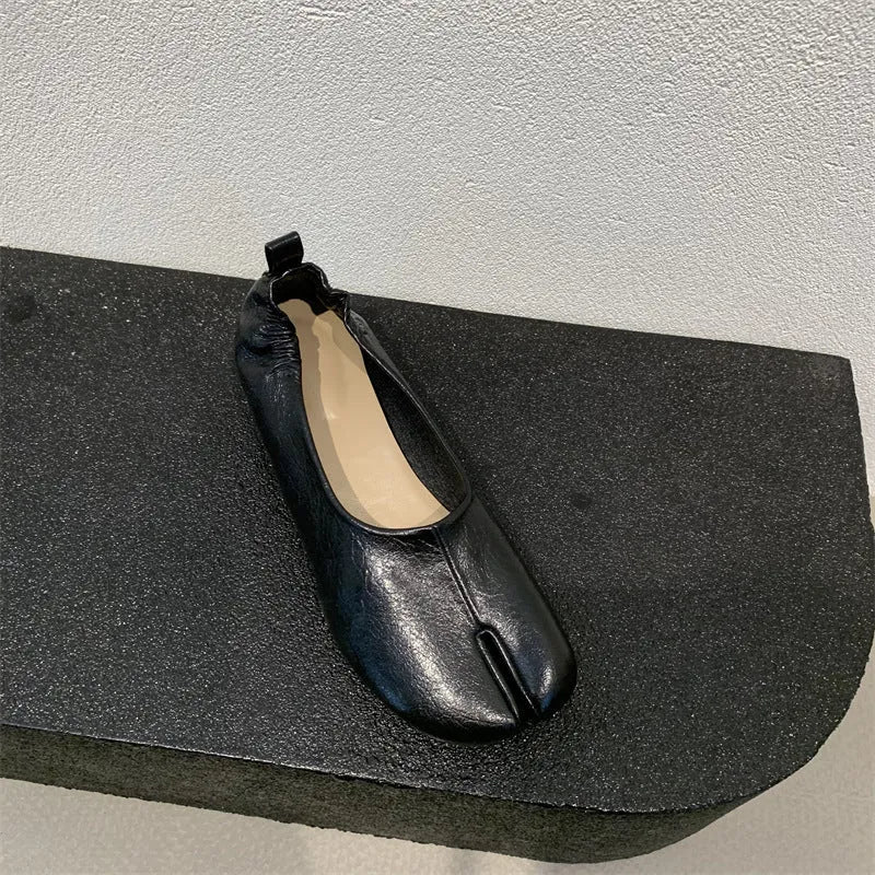Women's black split toe chunky heel pumps with round head and rubber sole on a white background.