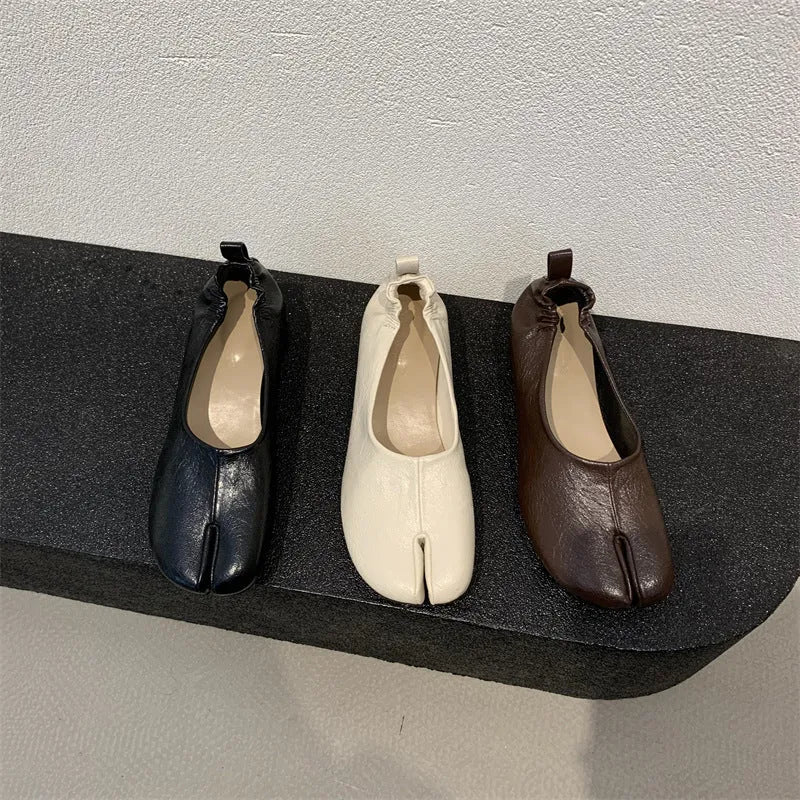 Women's black split toe chunky heel pumps with round head and rubber sole on a white background.
