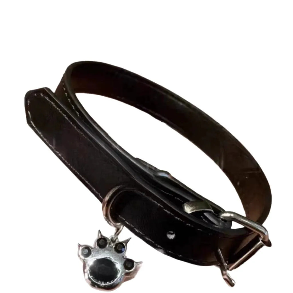 Black bell-shaped choker neck collar showing cat paw, bone, and leather style designs on an adjustable band.