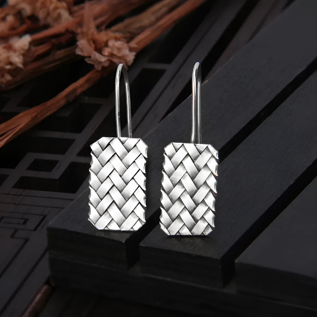 Silver geometric earrings with woven diamond plaid pattern measuring 17.5mm by 11mm