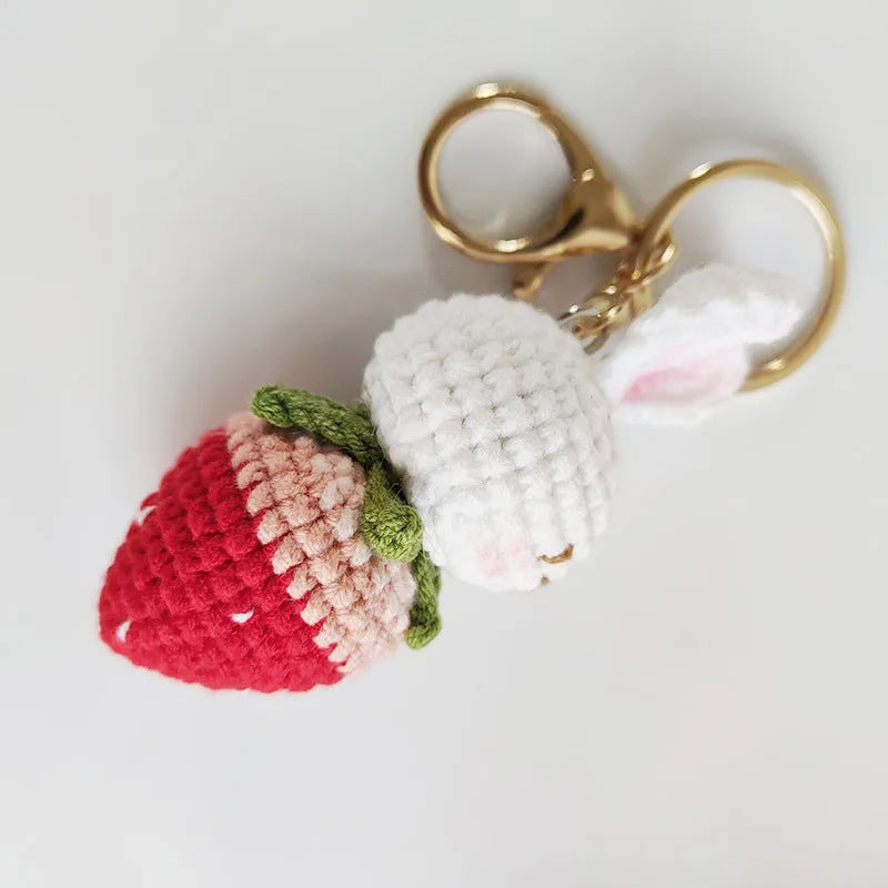 Hand-woven white wire rabbit pendant with strawberry design and key attachment