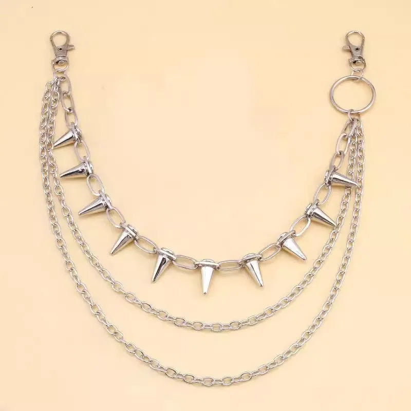 Silver double-layer pant chain with rivet accents and zipper details on dark trousers