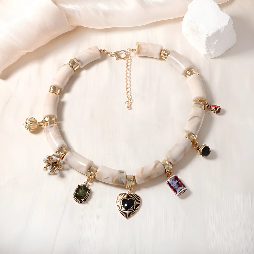 Electroplated resin bamboo heart pendant necklace with chain on white background