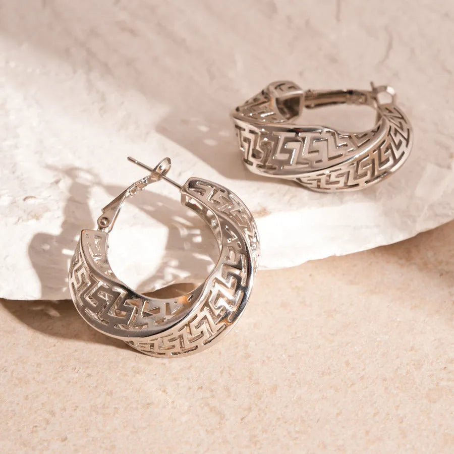 Women's geometric hollow stud earrings with exaggerated twisted round shape and electroplated silver finish