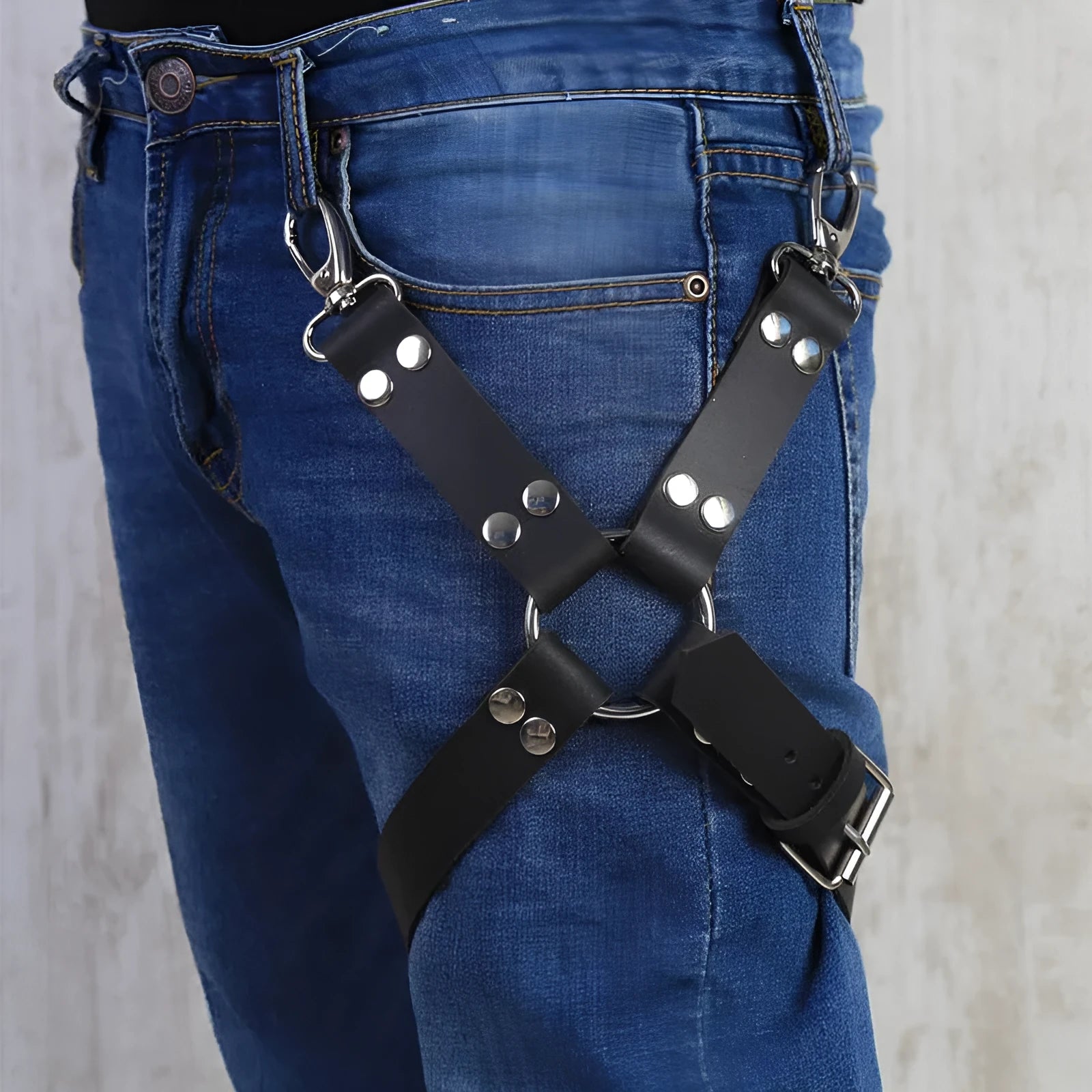 Black PU leather women's leggings on a hanger.