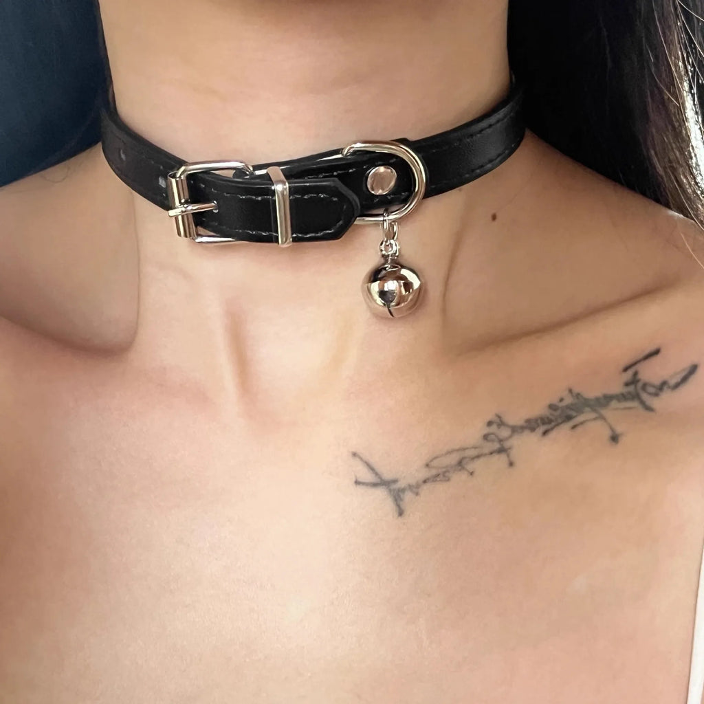 Black bell-shaped choker neck collar showing cat paw, bone, and leather style designs on an adjustable band.