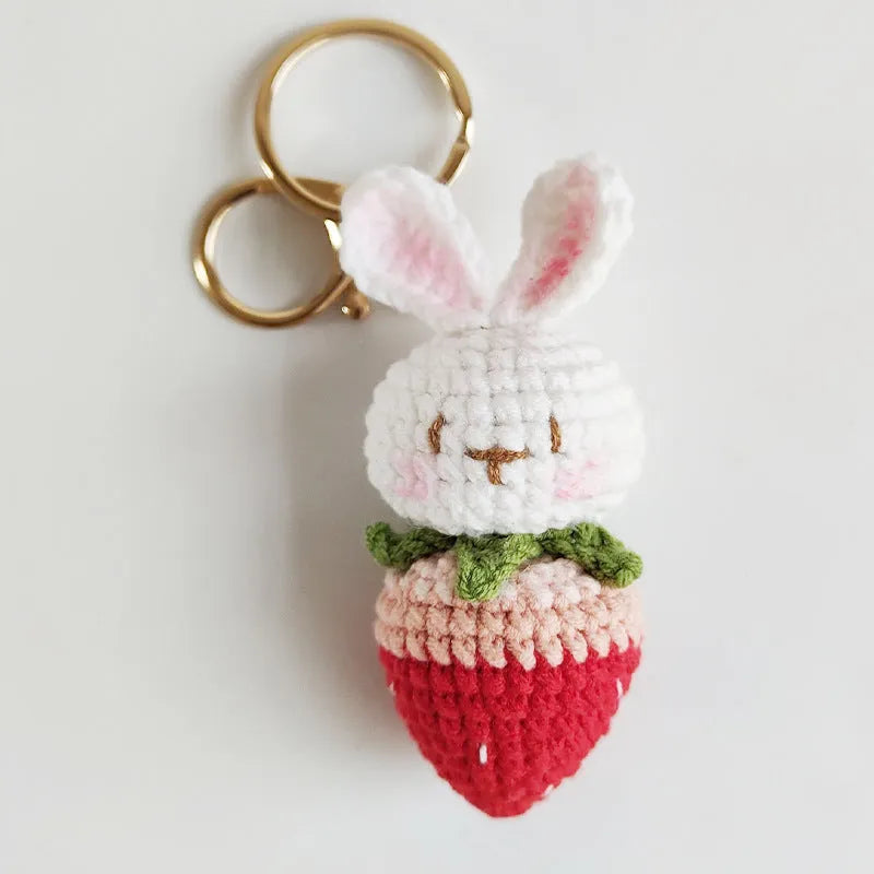 Hand-woven white wire rabbit pendant with strawberry design and key attachment