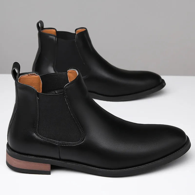 Men's black Chelsea boots with pointed toe design and decorative stitching