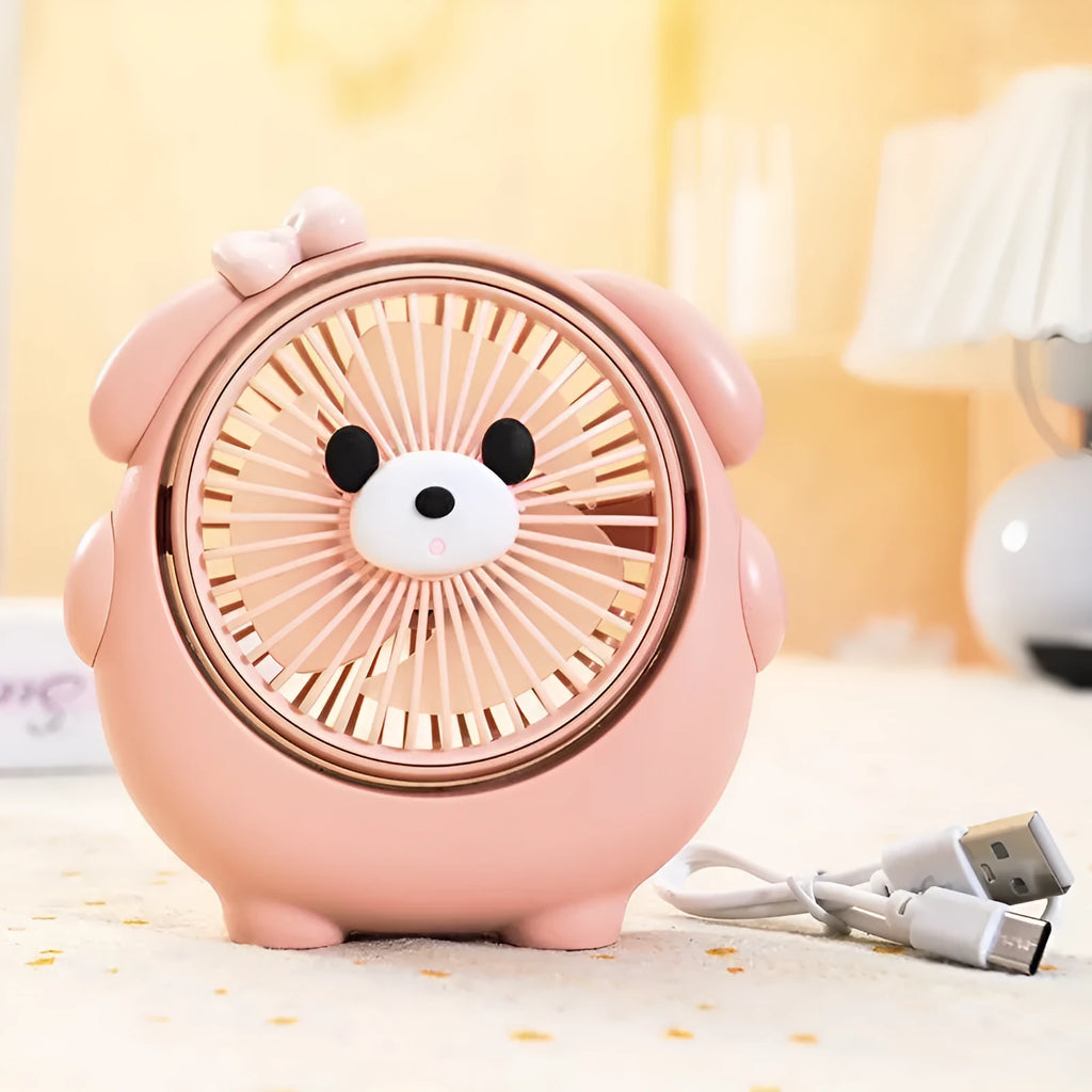 Dog-themed plastic USB desktop fan in Apricot Puppy colour on a wooden desk.
