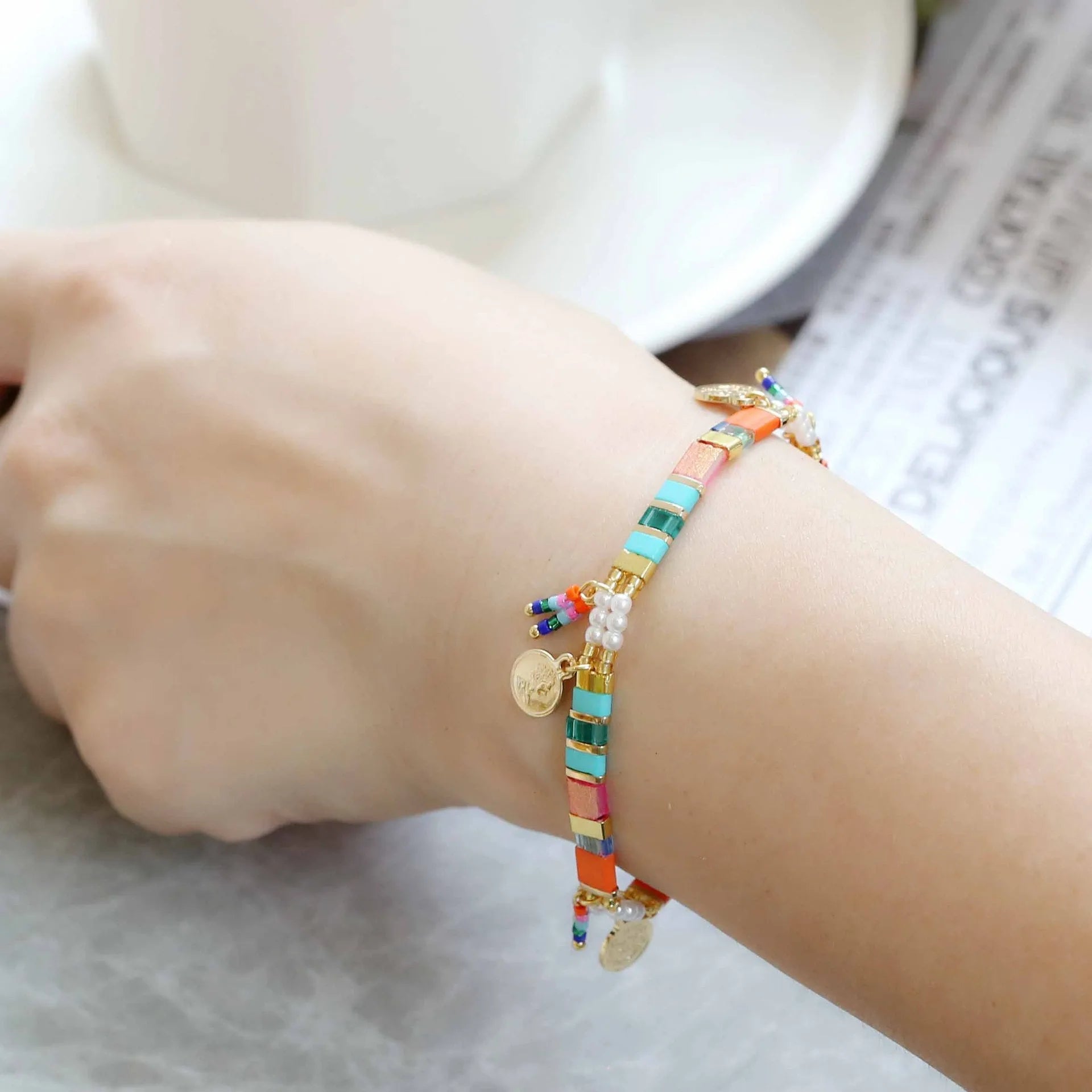 Women's handcrafted imitation pearl bracelet shown in one of six available colour variations.
