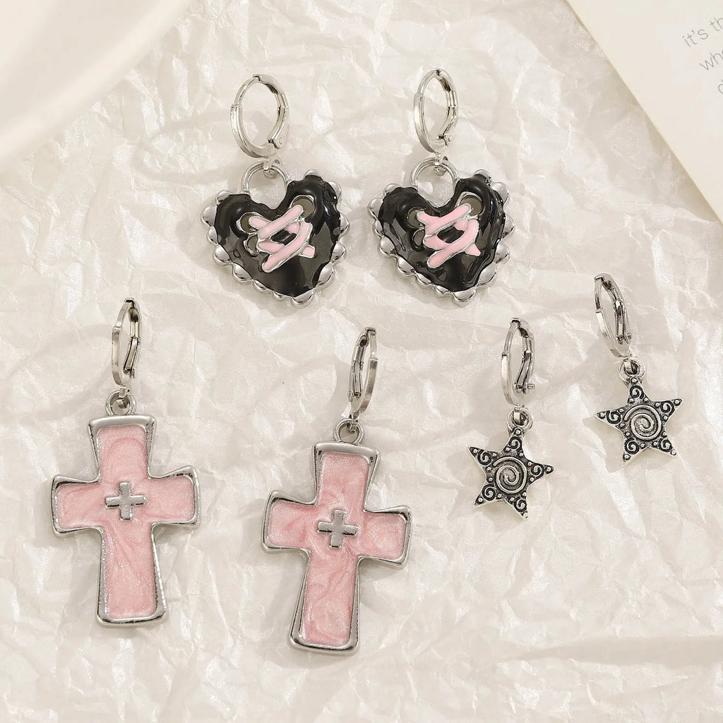 Women's alloy earrings with cross and heart designs in white, black, and silver colour options.