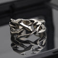 Copper geometric ring with thorn and flower design featuring adjustable opening