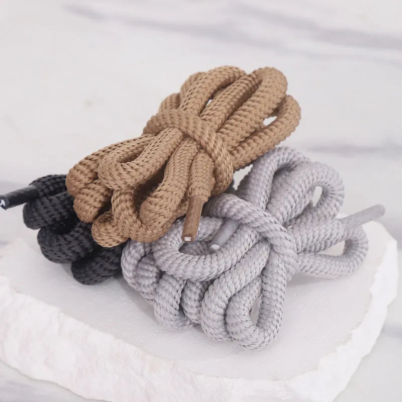 Round oval rope shoelaces in multiple colours including black, pink, blue, and red, shown in different lengths.