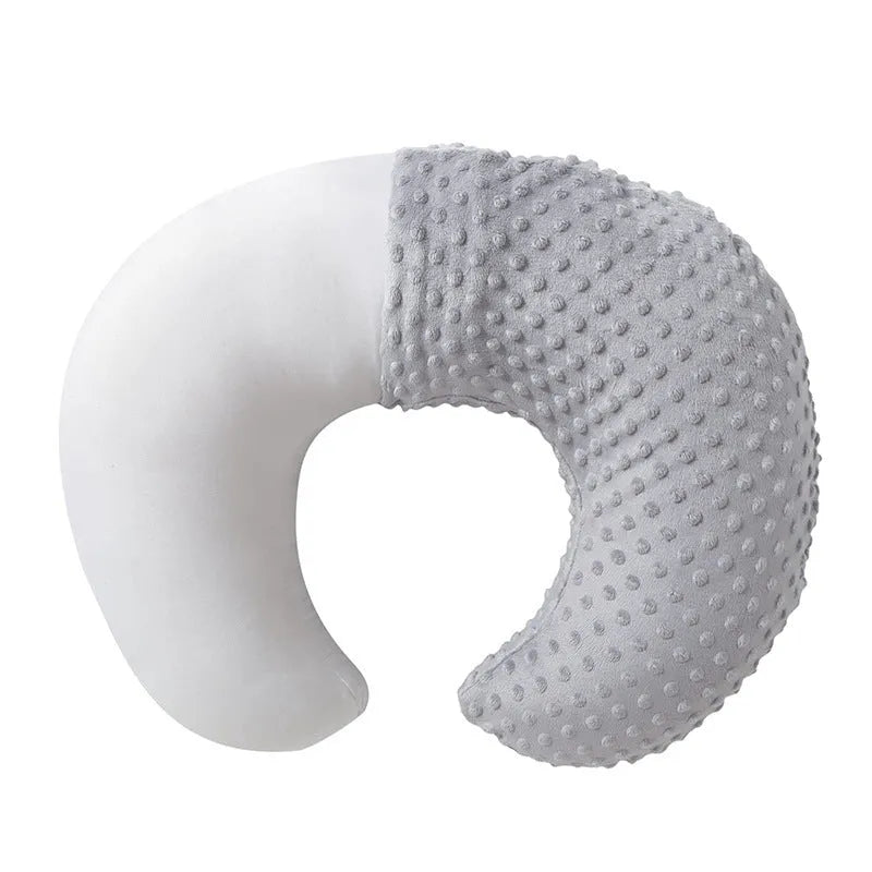 Pink nursing pillow for baby feeding support and spill prevention.