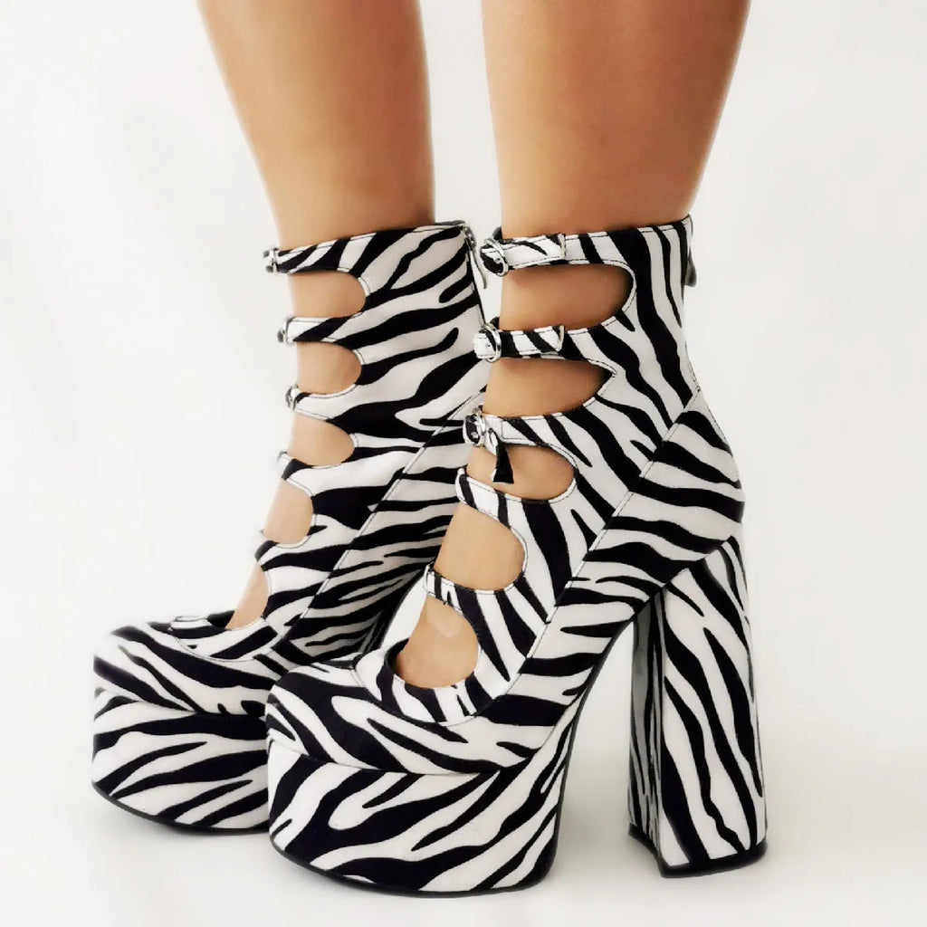 Women's black patent leather platform high heel boots with a thick heel and wrapped serpentine belt buckle