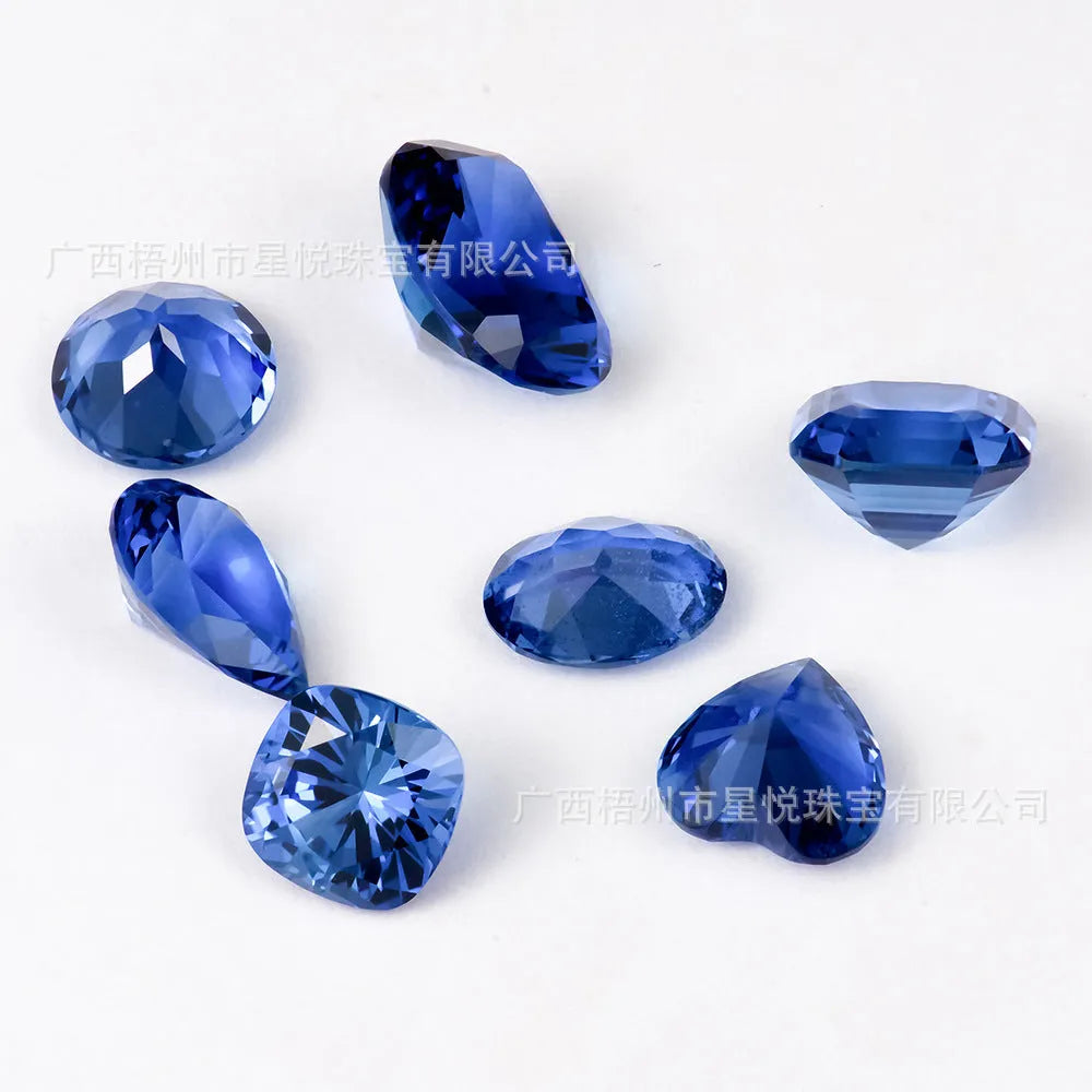 Royal Blue loose gemstone showing round and heart shapes on a grey background