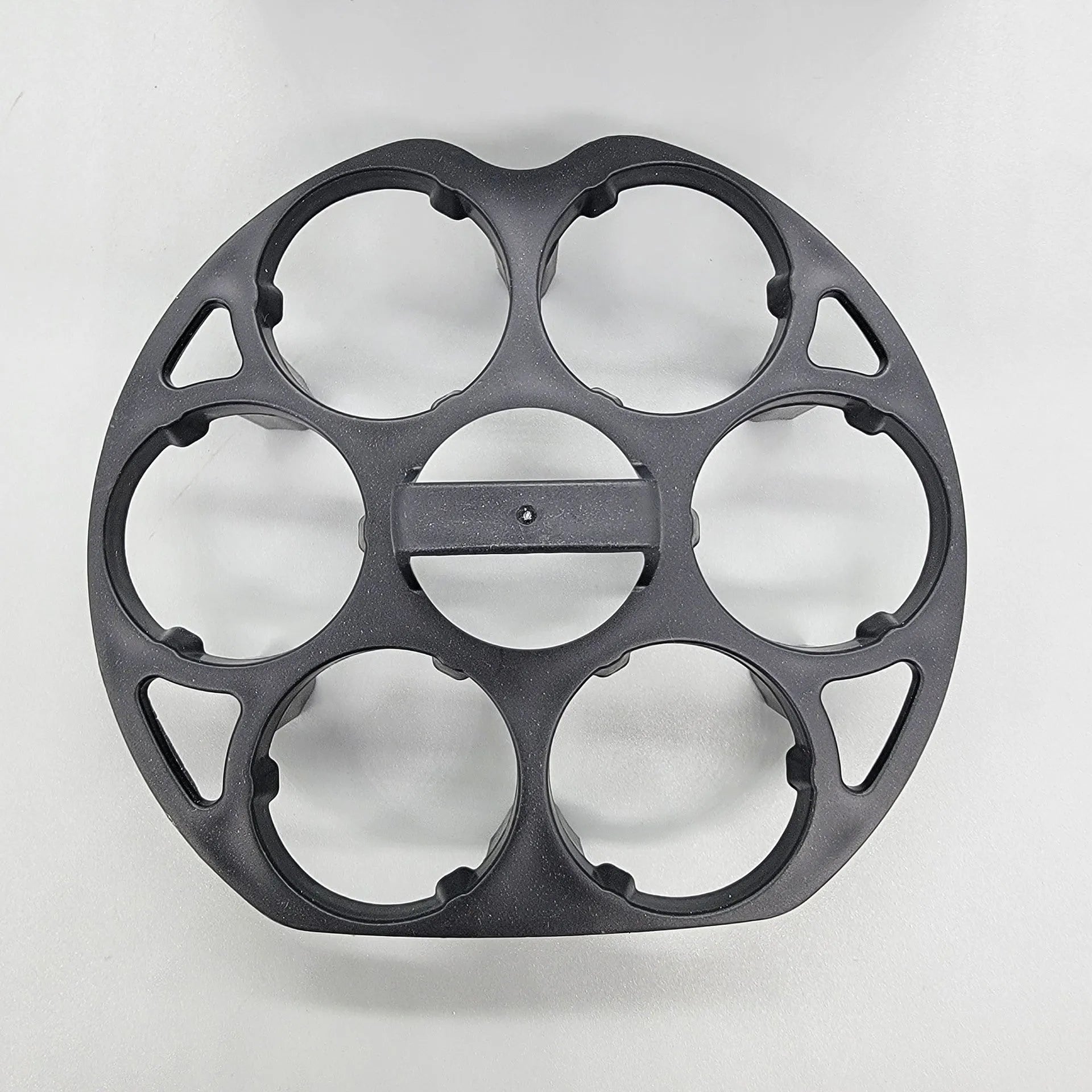 Black plastic egg holder basket for kitchen storage on a white background.
