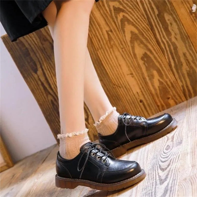 Women's black preppy retro Mary Jane pumps with low square heel and front lace-up.