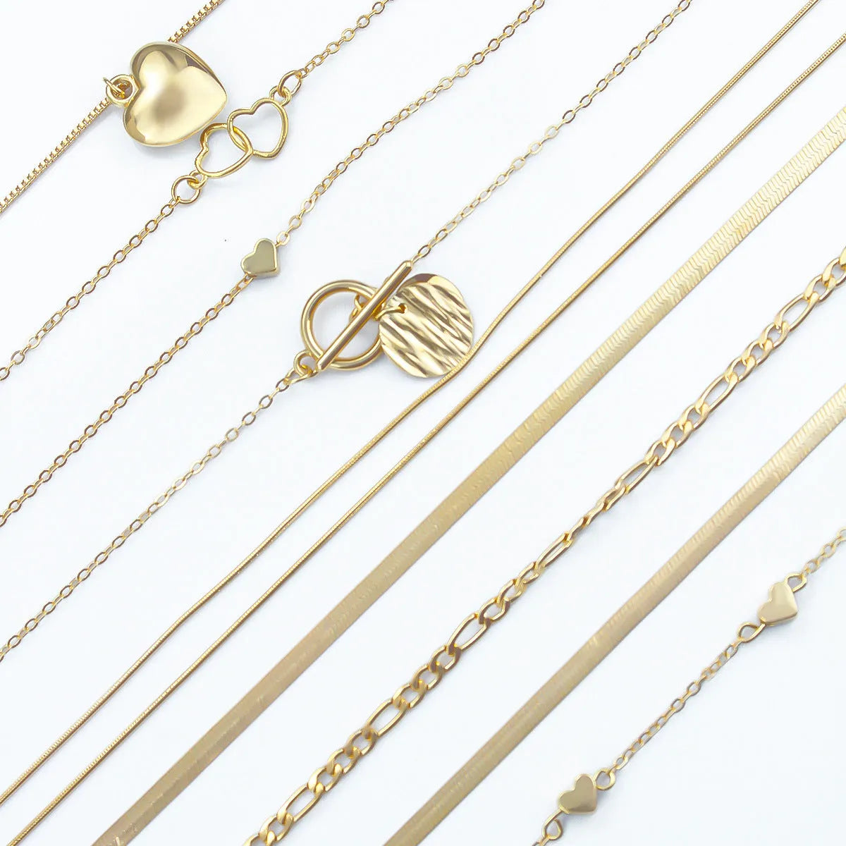 10 gold necklaces with snake bone chains and alloy pendants arranged in jewellery set