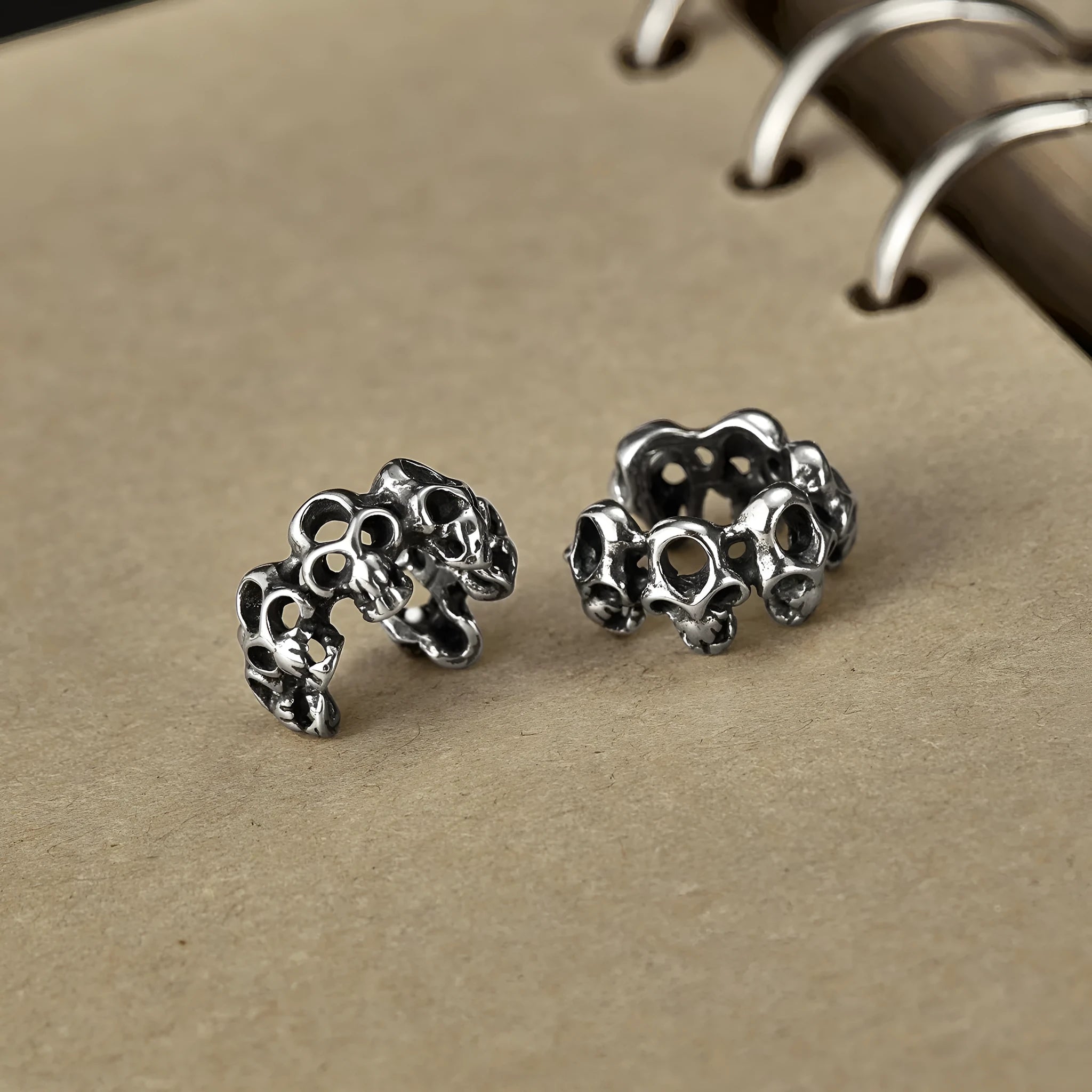 Stainless steel hollow skull earrings with electroplated finish and geometric design