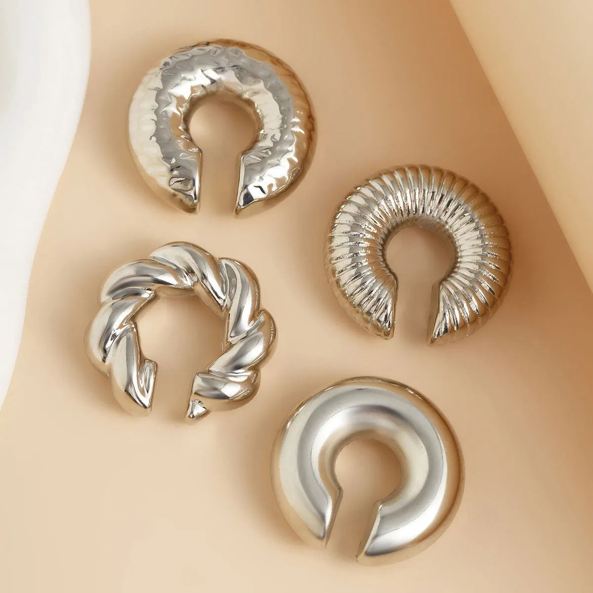 Set of four geometric clip-on earrings for women in gold and silver CCB alloy.
