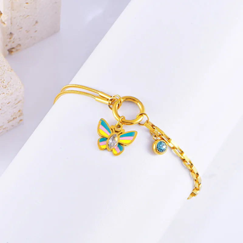 Gold titanium steel necklace and bracelet set with colourful epoxy butterfly zodiac pendant.