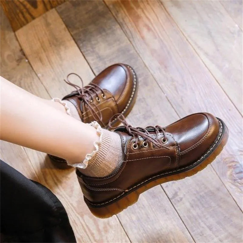 Women's black preppy retro Mary Jane pumps with low square heel and front lace-up.