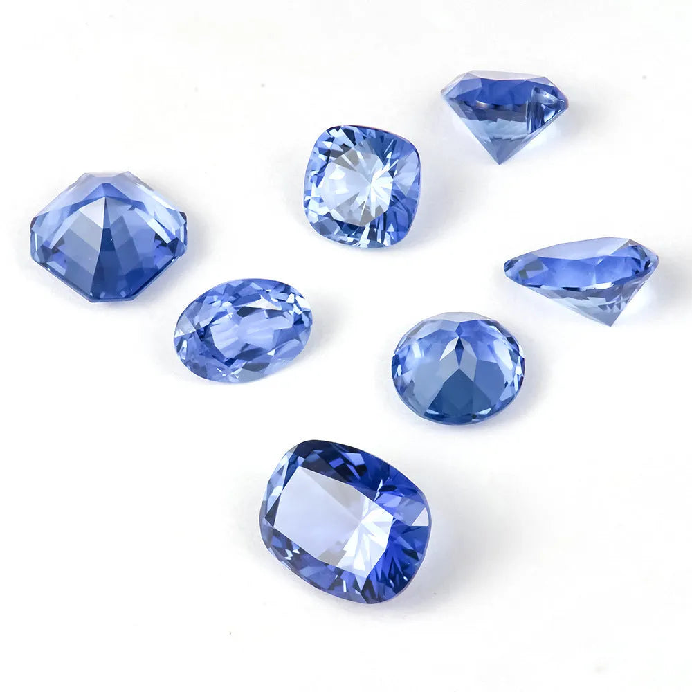 Royal Blue loose gemstone showing round and heart shapes on a grey background