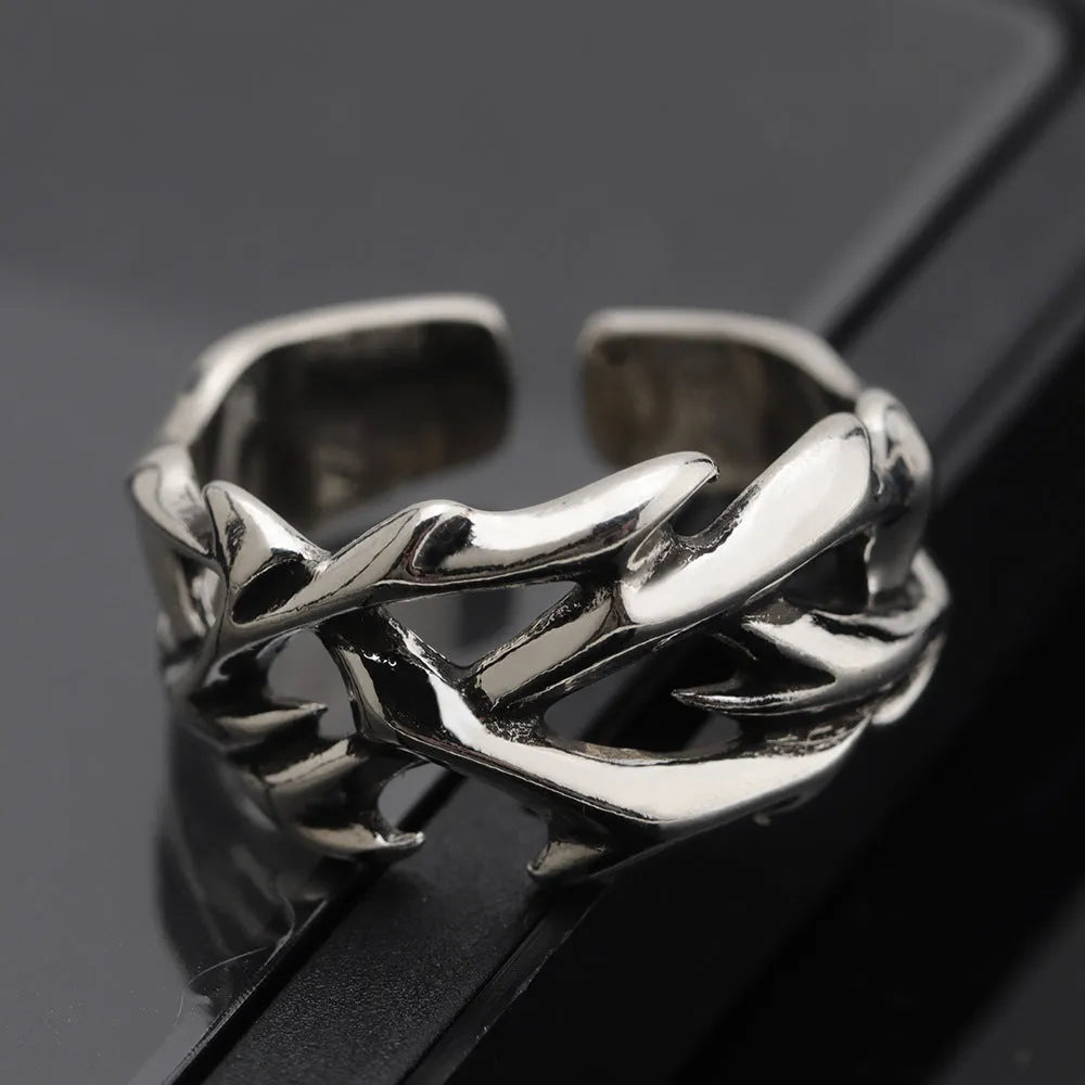 Copper geometric ring with thorn and flower design featuring adjustable opening