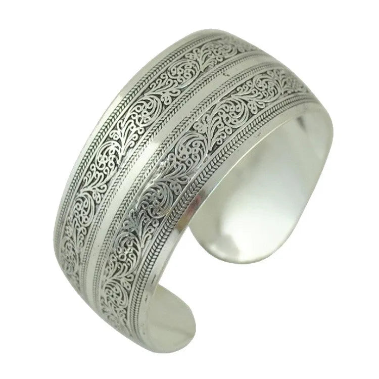 Open carved alloy bracelet with ethnic Miao-inspired patterns in adjustable design