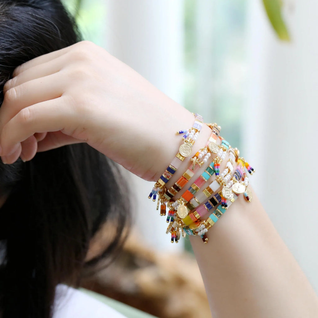 Women's handcrafted imitation pearl bracelet shown in one of six available colour variations.