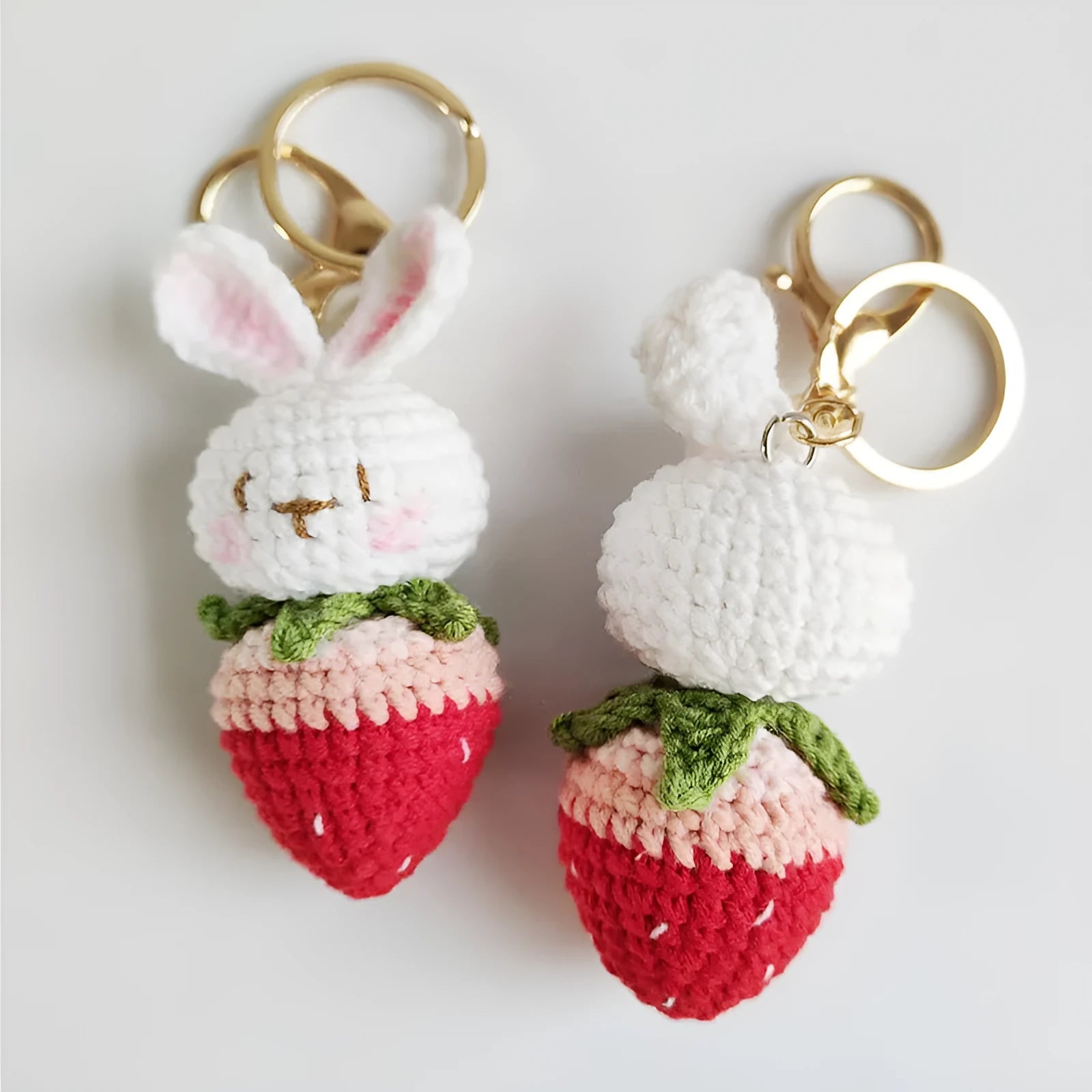 Hand-woven white wire rabbit pendant with strawberry design and key attachment