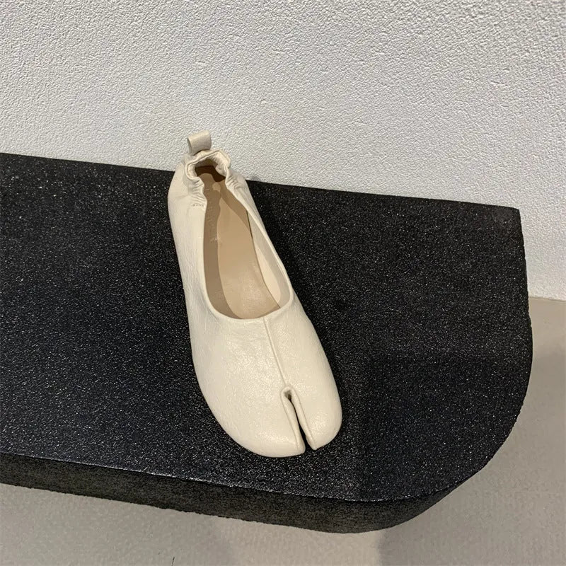 Women's black split toe chunky heel pumps with round head and rubber sole on a white background.