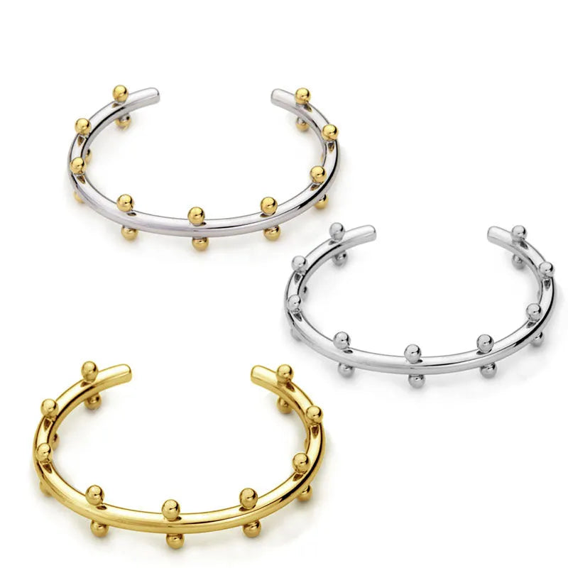 Stainless steel C-shaped bean bead with textured rivet surface in gold colour