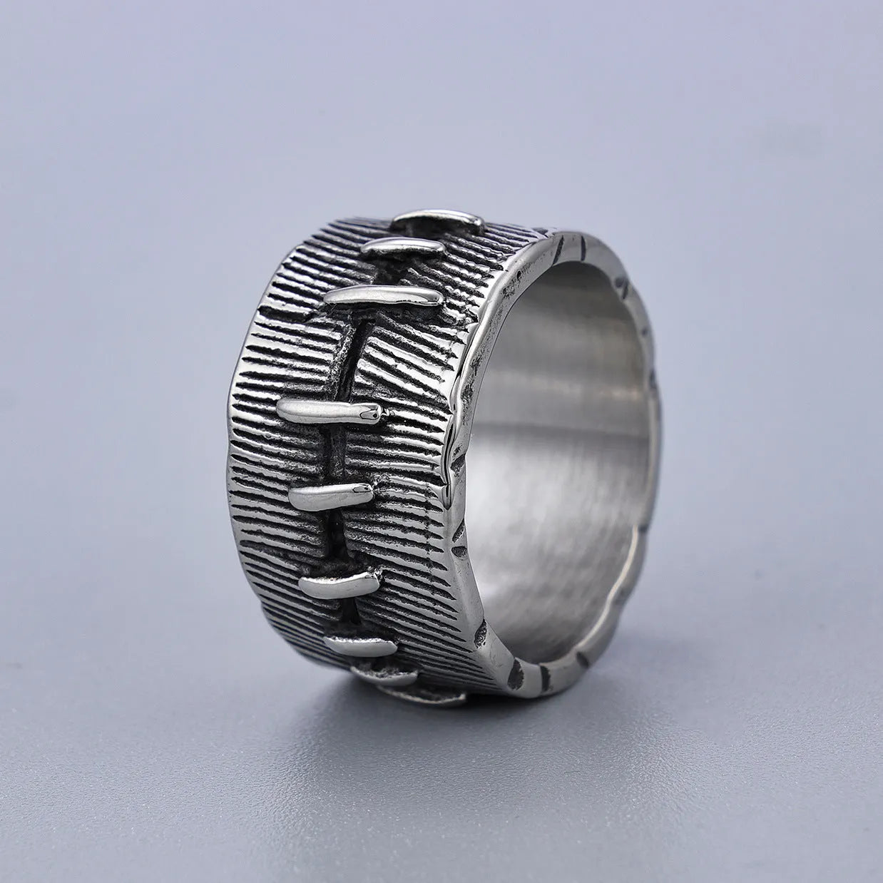 Dark punk titanium steel double ring with geometric U-shape design in retro colour on size guide background