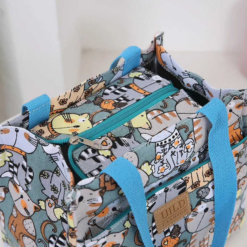 Women's printed canvas square handbag in a floral design, showing large capacity and structured shape.