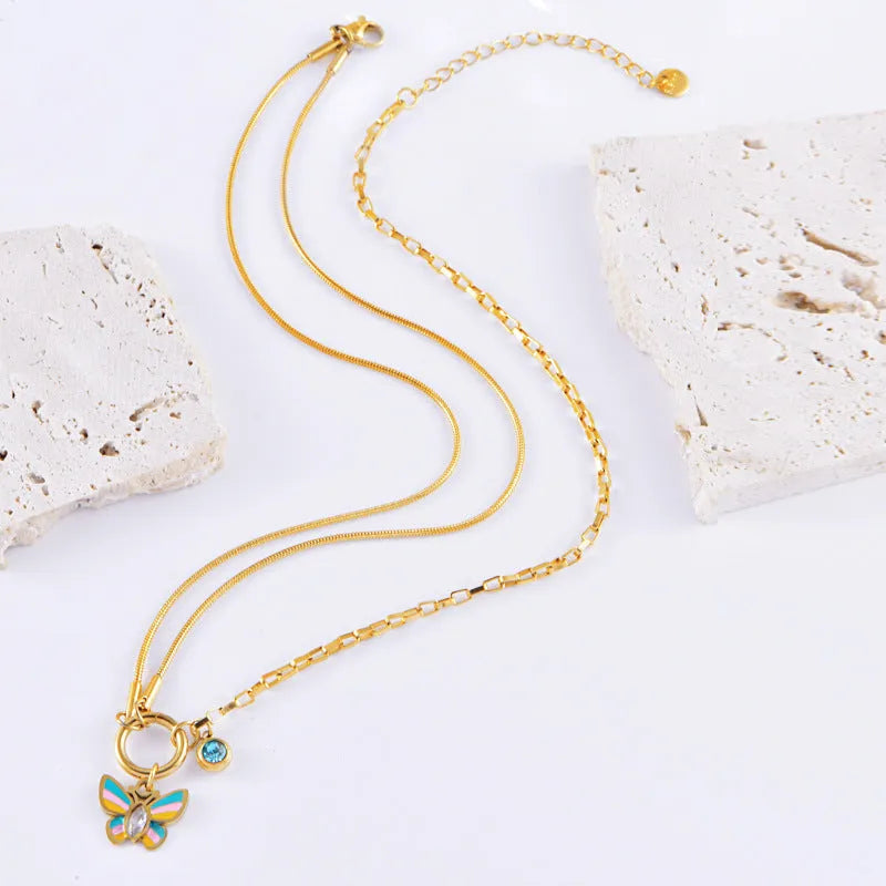 Gold titanium steel necklace and bracelet set with colourful epoxy butterfly zodiac pendant.