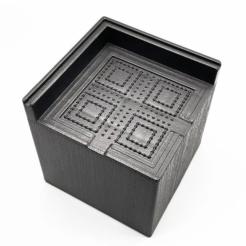 Four black plastic bed foot risers for furniture height adjustment