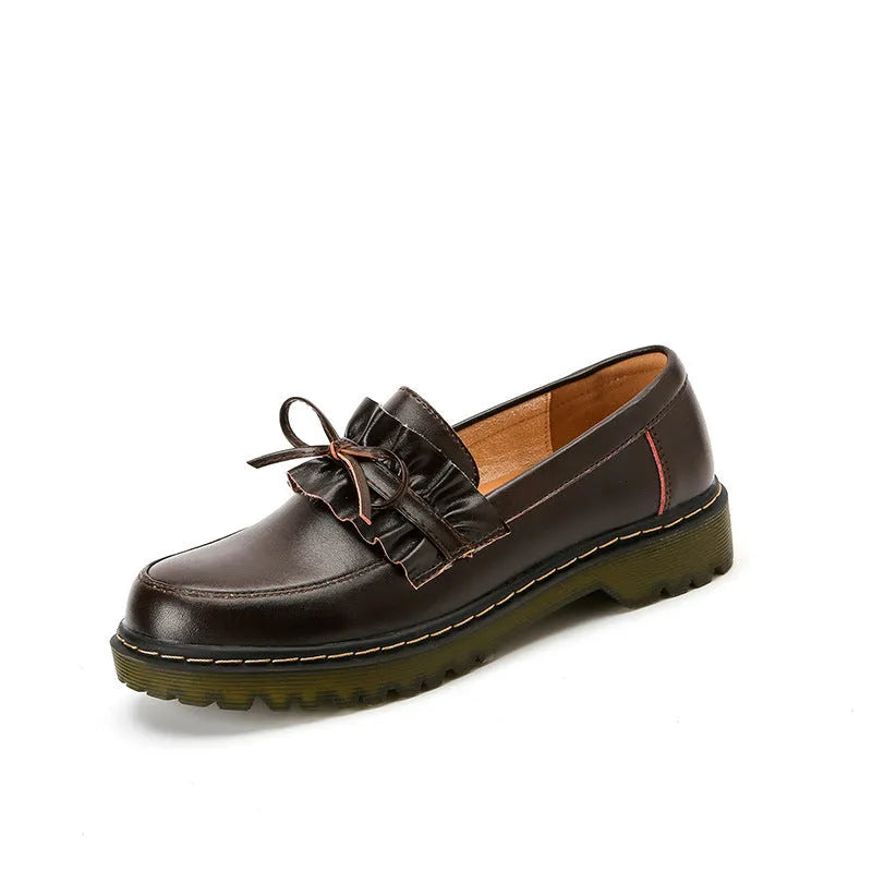 Women's black leather shoes with round toe and chunky flat heel, low-top design.