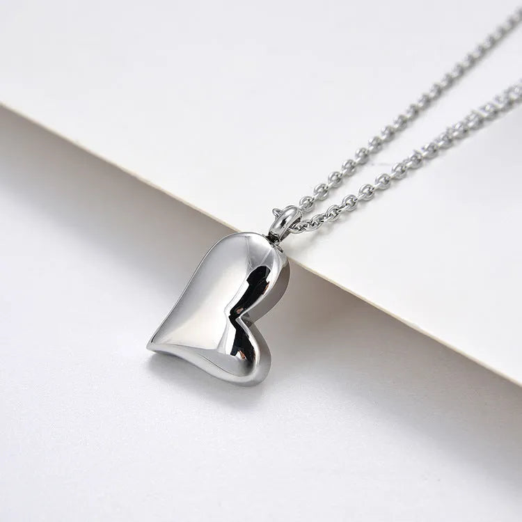 Silver curved peach heart pendant necklace on stainless steel chain with extension