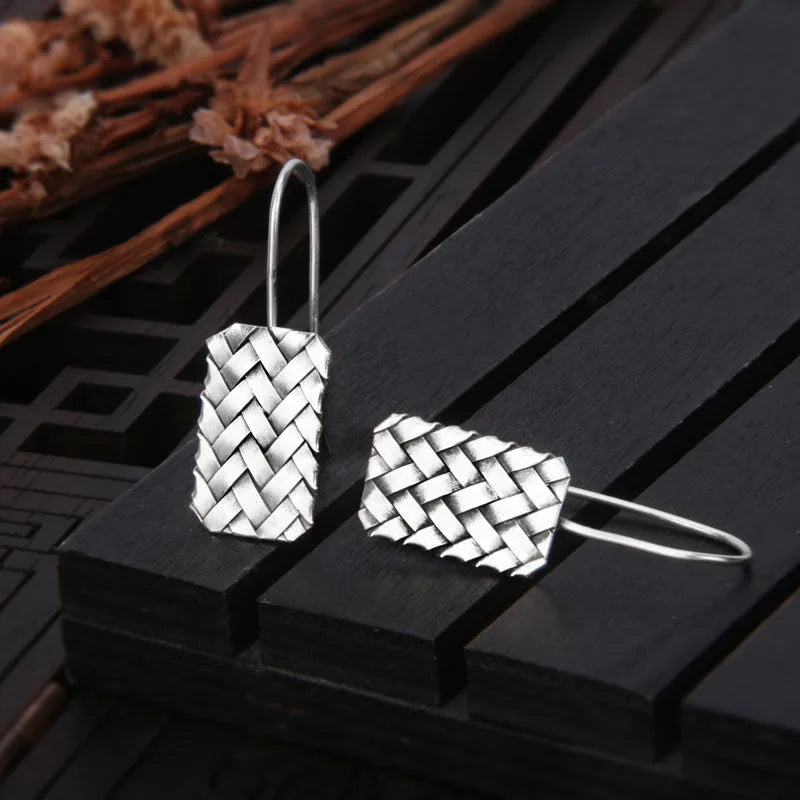 Silver geometric earrings with woven diamond plaid pattern measuring 17.5mm by 11mm